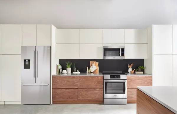 Stainless steel kitchen appliances in a mid-century modern kitchen